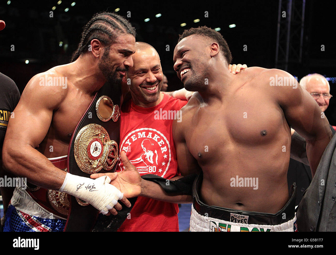 David Haye (left) and Dereck Chisora shake hands after their WBA and WBO International Heavyweight Championship bout, with trainer Adam Booth (centre) at Upton Park, London. Stock Photo