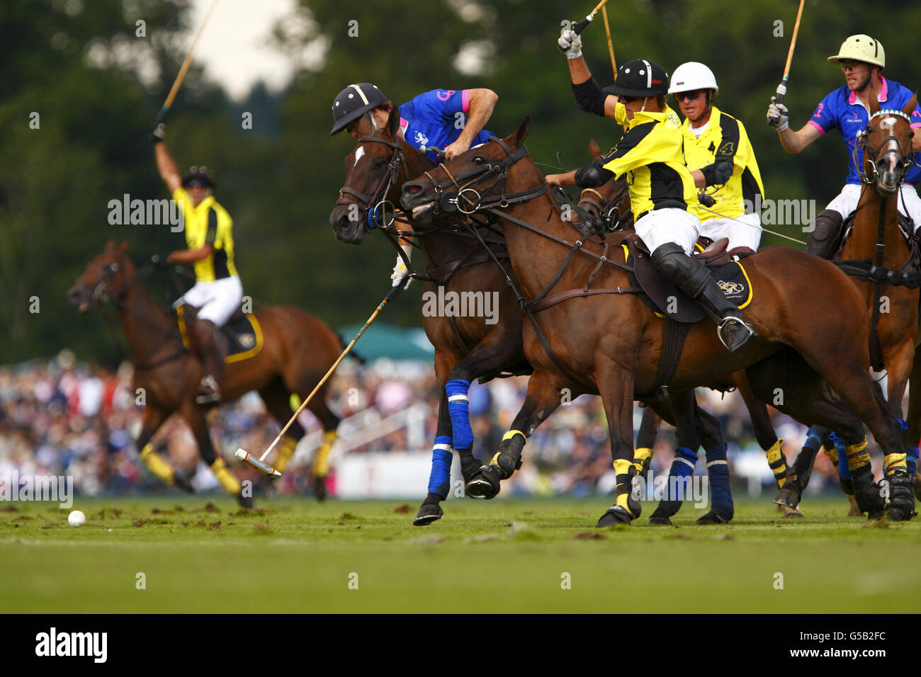 Action from West Sussex Cortium (yellow and black) and El Remanso in the Veuve Clicquot Gold Cup Final at Cowdray Polo Lawns in Midhurst, West Sussex. Stock Photo