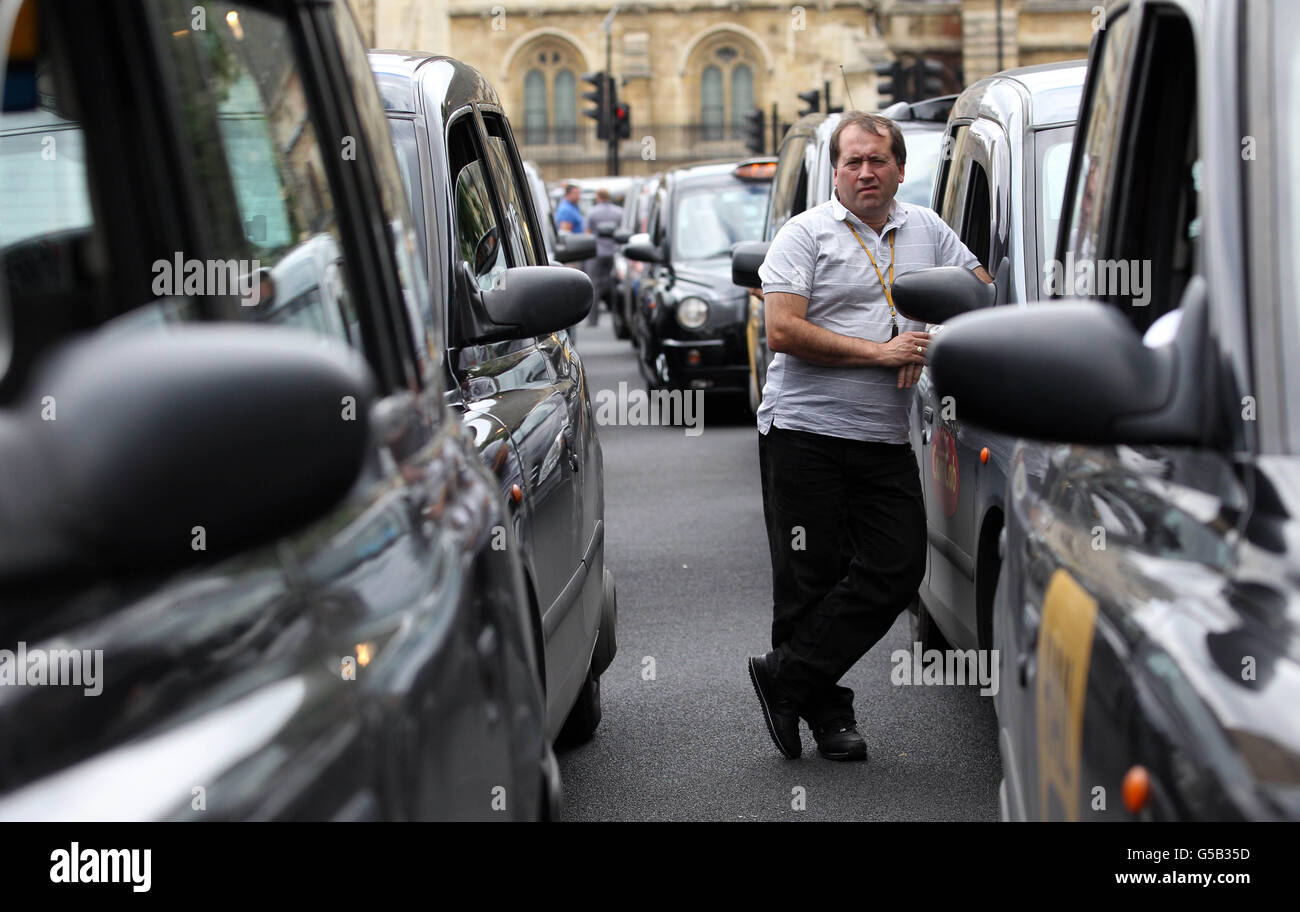 Taxi drivers demonstrate outside the Houses of Parliament, London, in a ...
