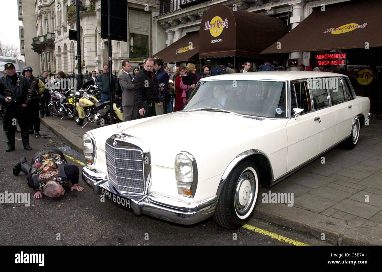 A Mercedes-Benz 600 Pullman Limousine formerly owned by John Lennon pulls up outside the Hard Rock Cafe in London, 27 March 2001, where it is to be auctioned live and over the internet for upwards of 400, 000. *The made-to-order limousine was pop genius Lennon's pride and joy, and is being put under the hammer today after more than 200,000 was spent on its renovation. Stock Photo