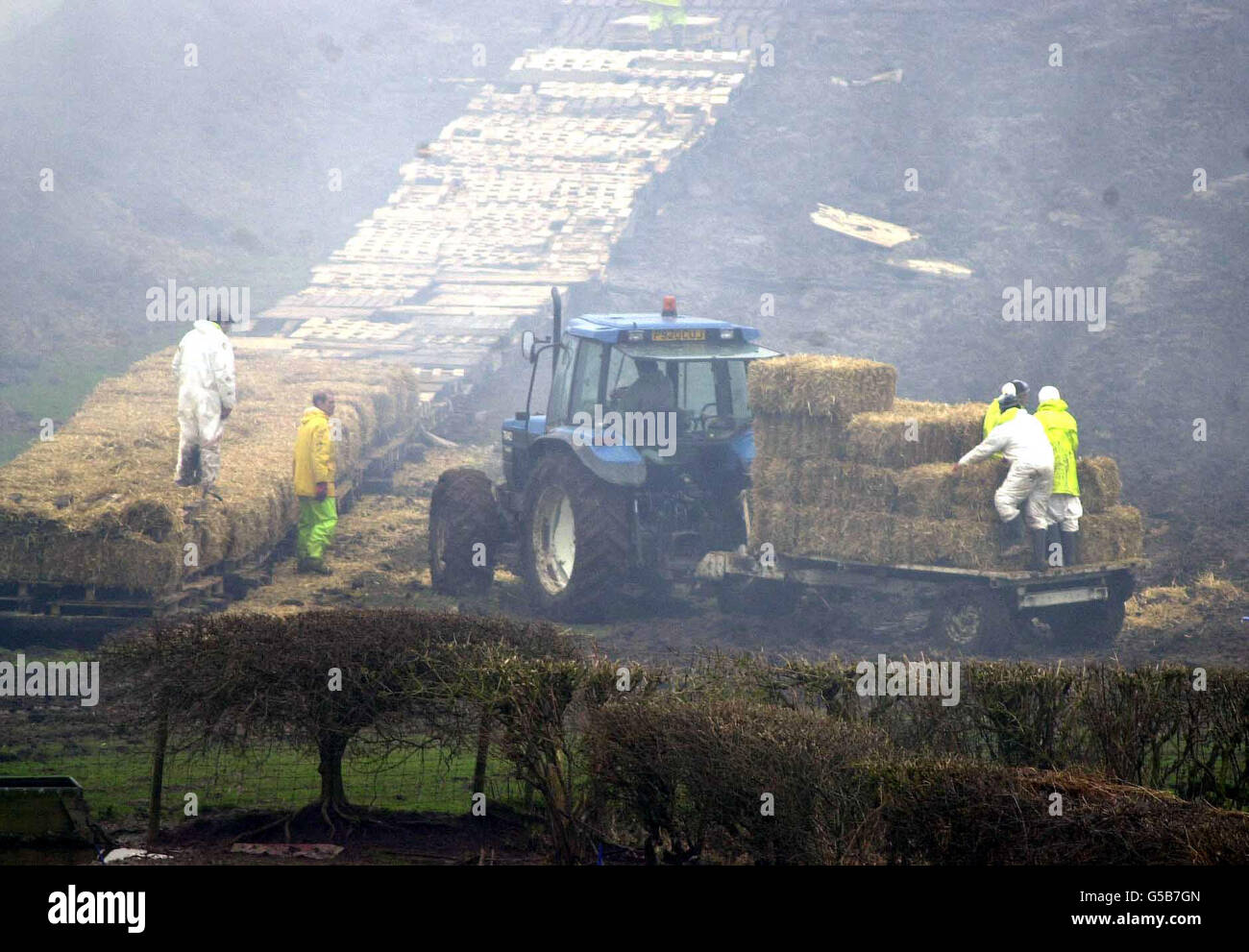 Workers prepare the pyre at Nibley Mill farm in Blakeney ...