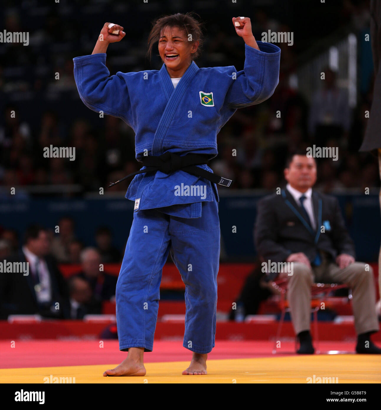 Brazil's Sarah Menezes celebrates her victory in Gold medal contest against Romania's Alina Dumitru during the Women's Judo at the ExCel Arena, London. Stock Photo