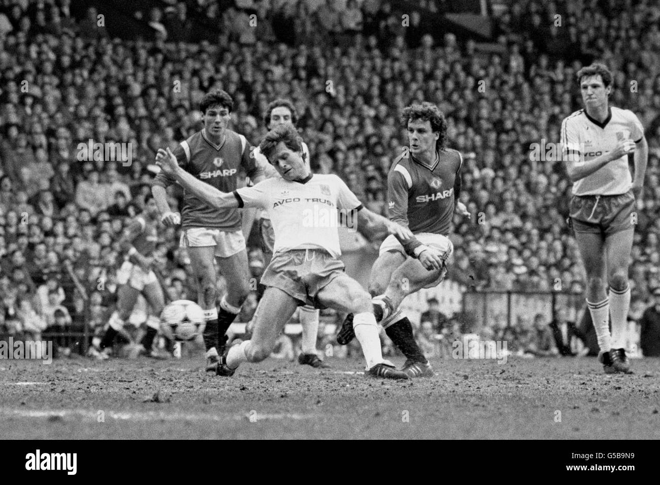 Manchester United's striker Mark Hughes (right) blasts the ball home for United's first goal versus West ham at Old Trafford ground, Manchester. Team mate Frank Stapleton watches. Stock Photo