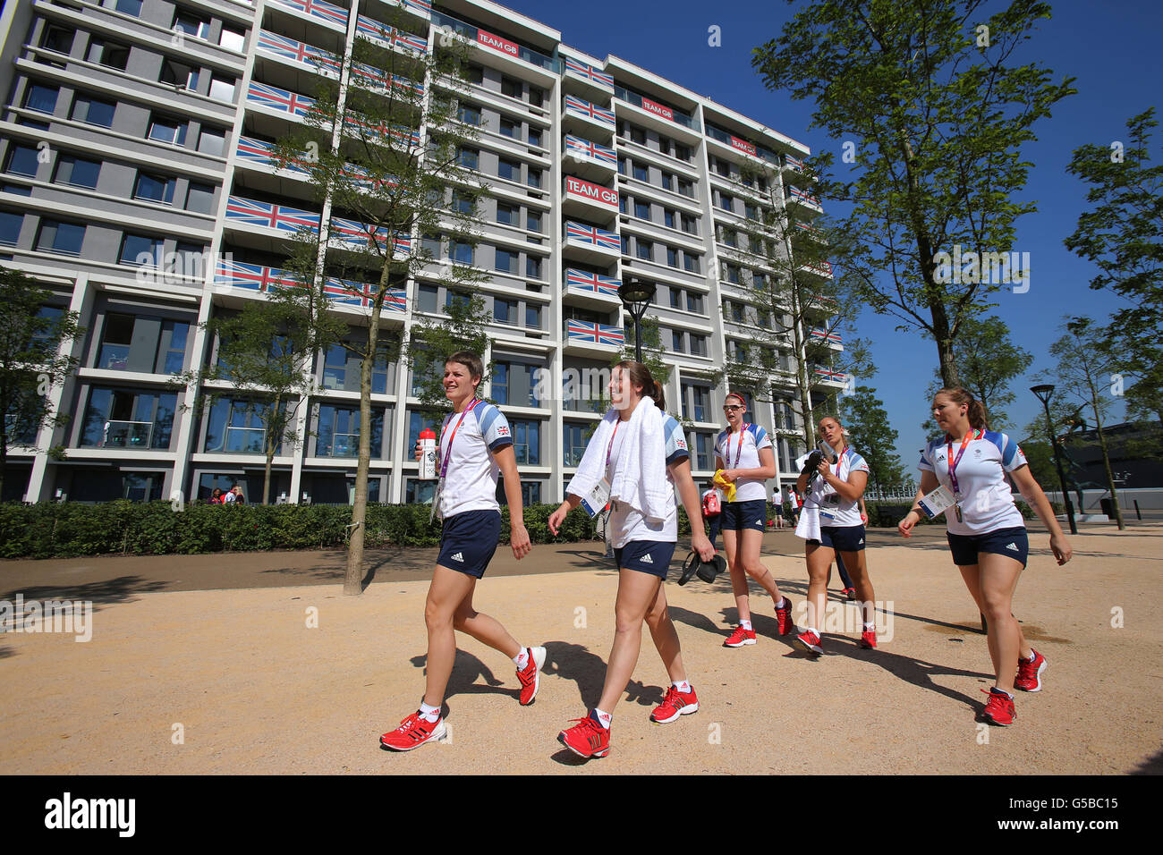GB Athletes walk past their accommodation at the Athletes Village at the Olympic Park, London. Stock Photo