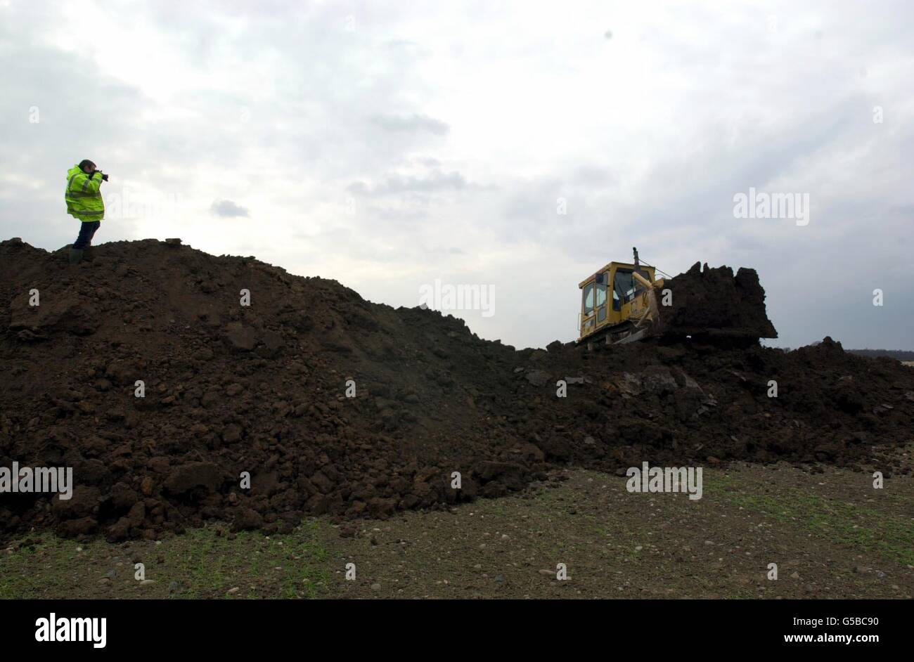 Heavy earth-moving equipment at work on the disused airfield in Great Orton near Carlisle, where the carcasses of up to 500,000 animals could be buried at the first foot-and-mouth mass grave. Stock Photo