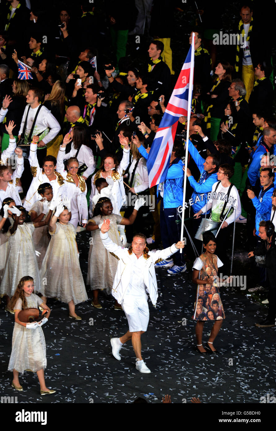 Great Britain's Sir Chris Hoy carrying the Britsh flag leads the teamduring the London Olympic Games 2012 Opening Ceremony at the Olympic Stadium, London. Stock Photo
