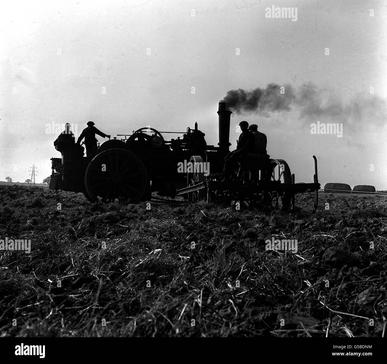 FARM TRACTION ENGINE 1964: A silhouette from bygone times is seen across the fields at Mr Harold Jackson's Thurston's Farm at Stambourne, Essex. The two 200hp engines, bought in November 1918, are hard at work in the fields around Stambourne whenever the weather is suitable. Stock Photo