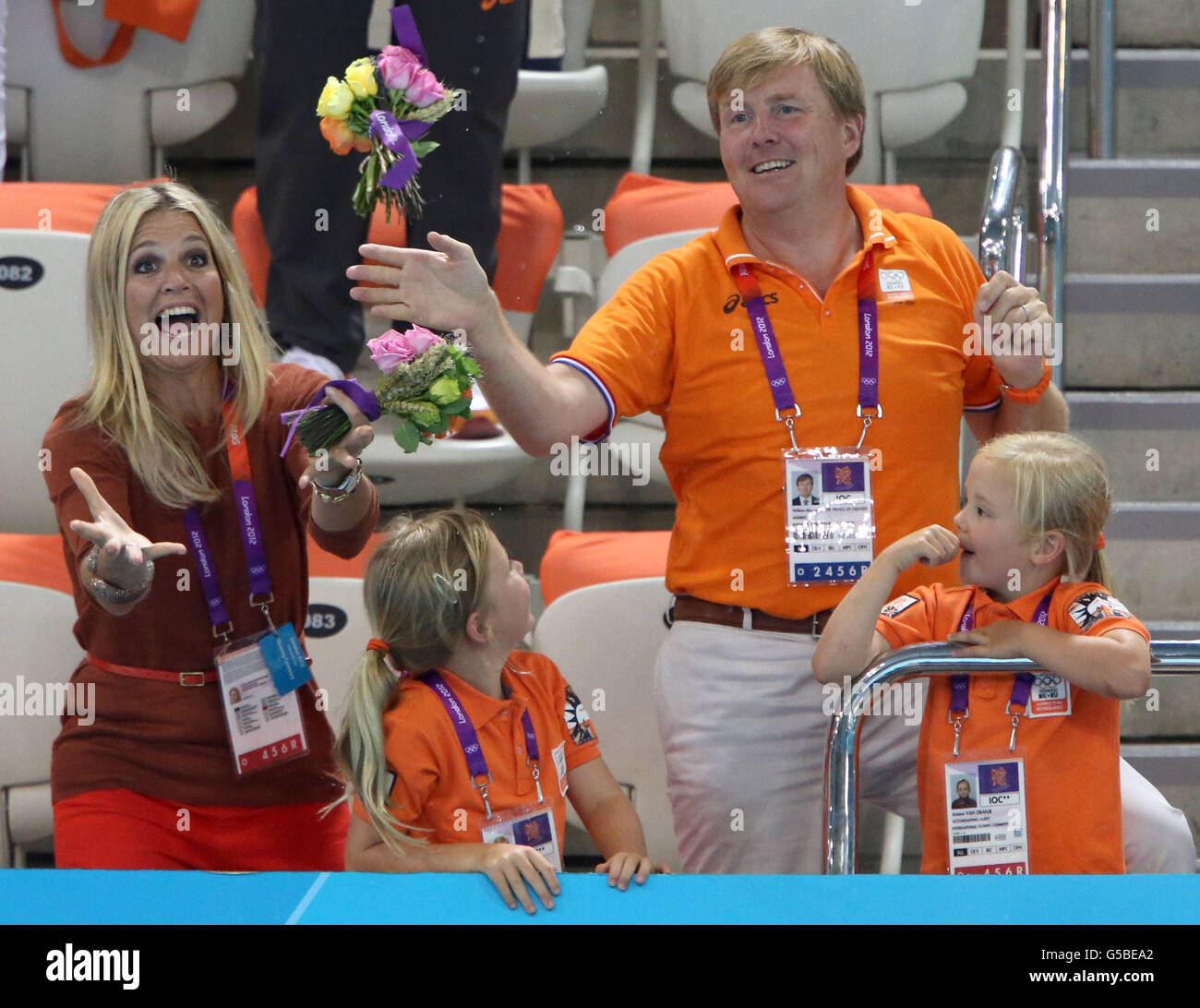 William Alexander Prince of Orange and Princess Maxima try to catch a bouquet thrown by the Netherlands Women's 4 x 100m Freestyle team at the Aquatics Centre, London. Stock Photo