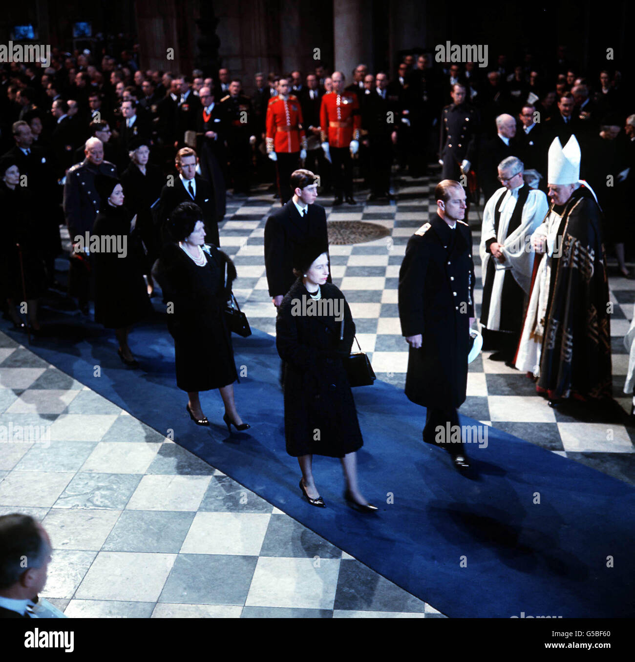 The Queen and the Duke of Edinburgh lead mourners inside St. Paul's Cathedral, London, during the funeral service for Sir Winston Churchill. Behind are the Queen Mother and Prince Charles (later the Prince of Wales). Stock Photo