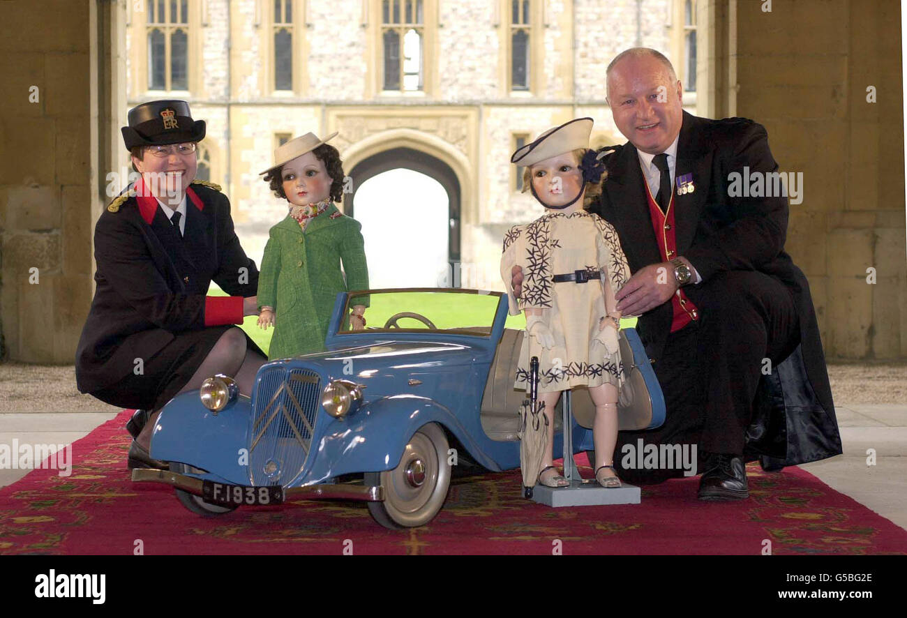 Head Warden Claude Bikoro (L) and Livery Porter John Emery with unique porcelain dolls from the Royal Collection. France (L), and Marianne, and a miniature Citroen 7B were presented to the King George VI and Queen Elizabeth. * for the Queen and Princess Margaret, to mark the State visit to France in 1938. The dolls and the car were reunited at Windsor Castle after fifty years of separation. Stock Photo
