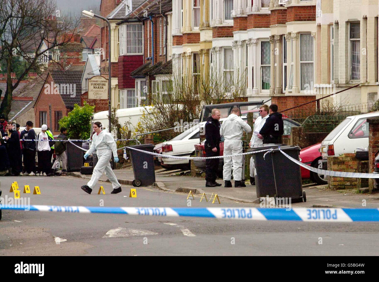 Scenes of crime officers at work at the site of a shooting incident in
