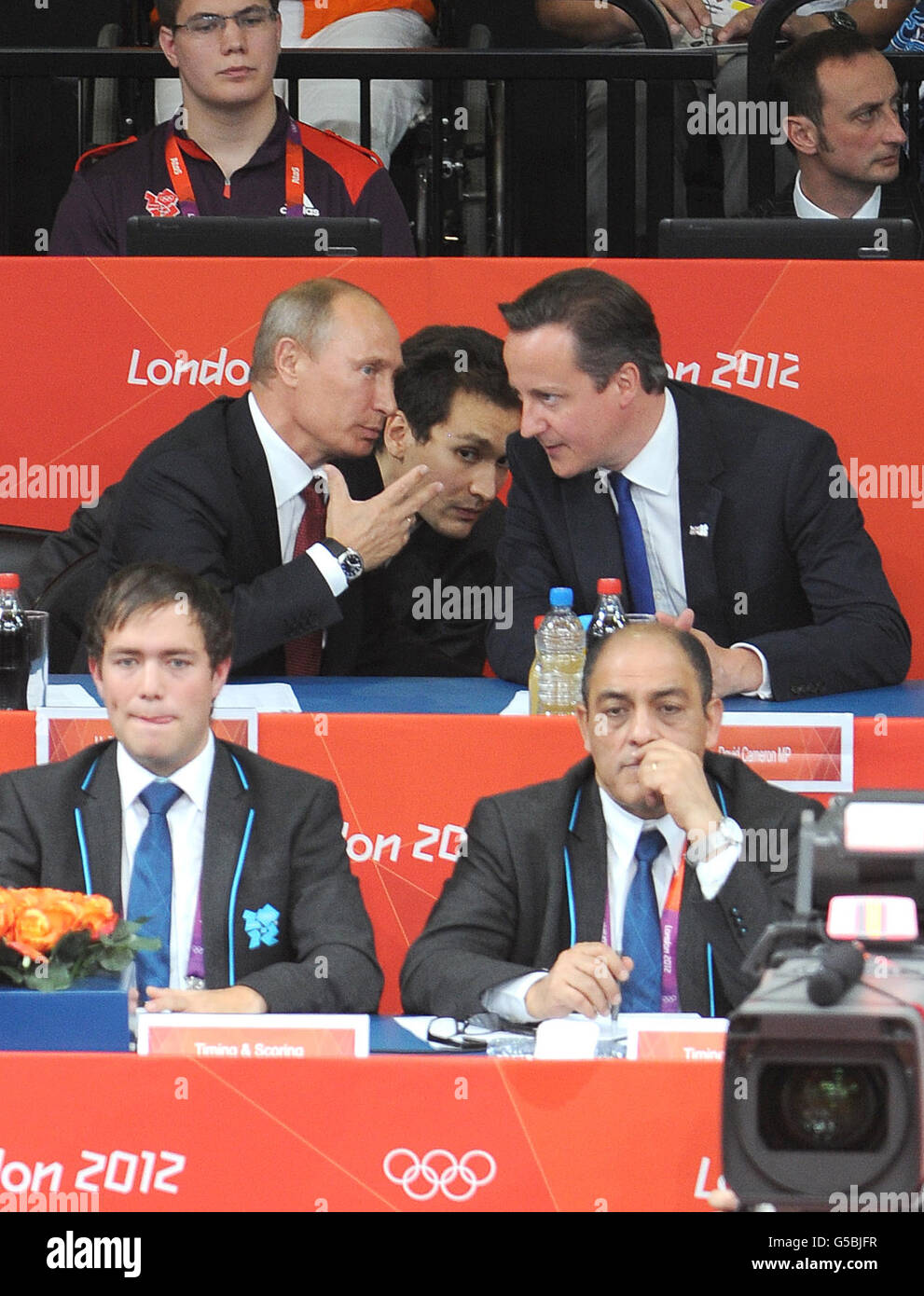 Prime Minister David Cameron and Russian President Vladimir Putin (left)talk during the Women's Judo 78kg semi-final in the North Arena at the ExCel, London, on the sixth day of the London 2012 Olympics. Stock Photo