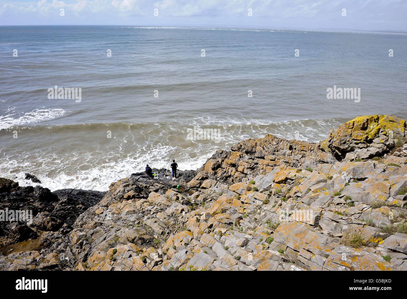 People fish at a place known locally as 'Blue Pool' near Llangennith, near Swansea, Wales, where a boy died after falling into the waters. Stock Photo