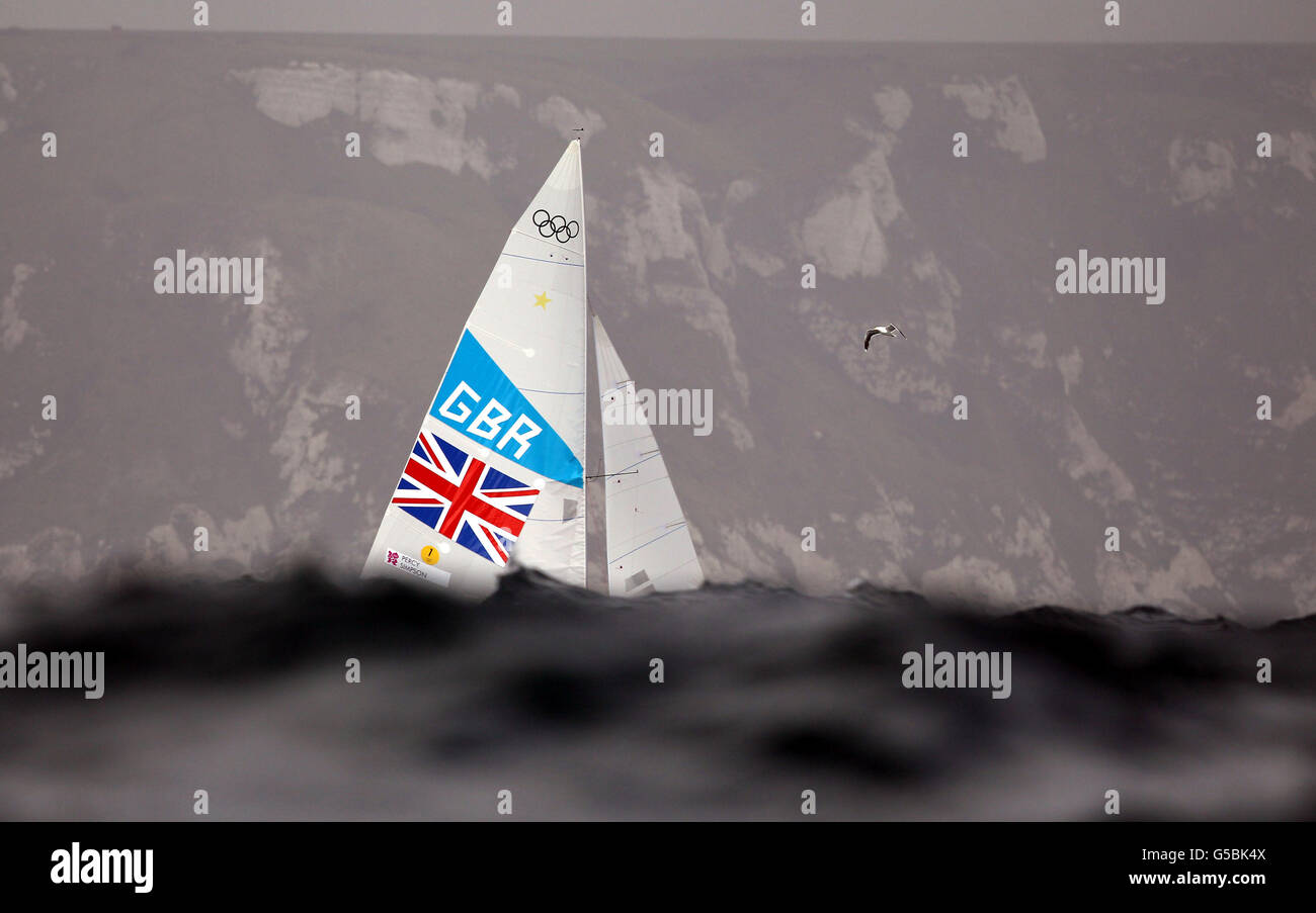 Great Britain's Star sailors Iain Percy and Andrew Simpson hidden by the swell rolling in to Weymouth Bay during the seventh race of their Olympic series off Weymouth today. Stock Photo