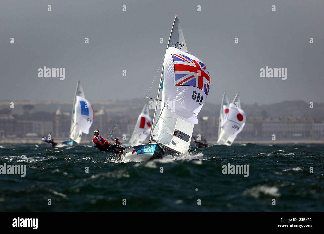 Great Britain's 470 sailors Luke Patience and Stuart Bithell who lead the fleet after the first two races of theri Olympic competition off Weymouth today. Stock Photo