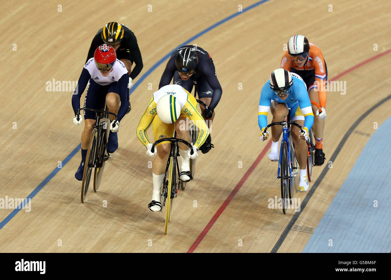 Australia's Anna Mears (yellow) leads Great Britain's Victoria Pendleton (left) in the first round of the Women's Keirin at the Velodrome in the Olympic Park, during day seven of the London 2012 Olympics. Stock Photo