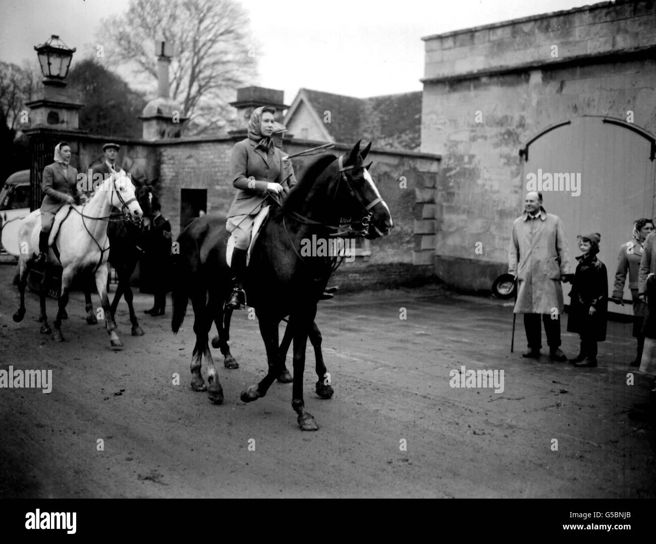 Queen Elizabeth II, accompanied by the Duke of Beaufort, returns from a morning ride at Badminton, Gloucestershire, on the last day of the Badminton Horse Trials. Princess Margaret, the Queen's sister, can be seen behind. Stock Photo