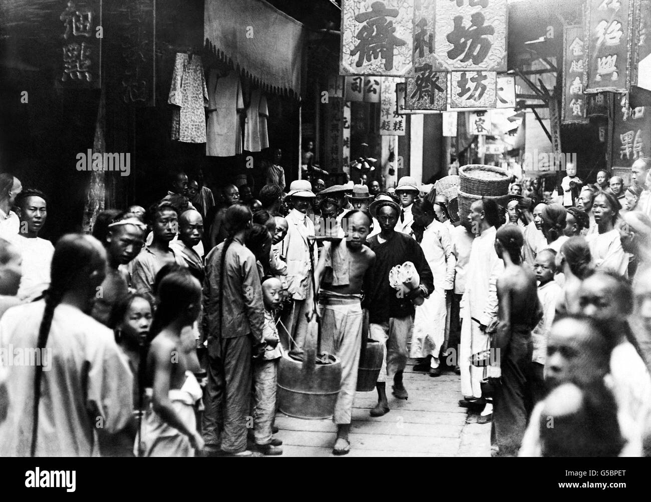 A typical scene on a bustling street in the native quarter of the Chinese city of Hankow. Stock Photo