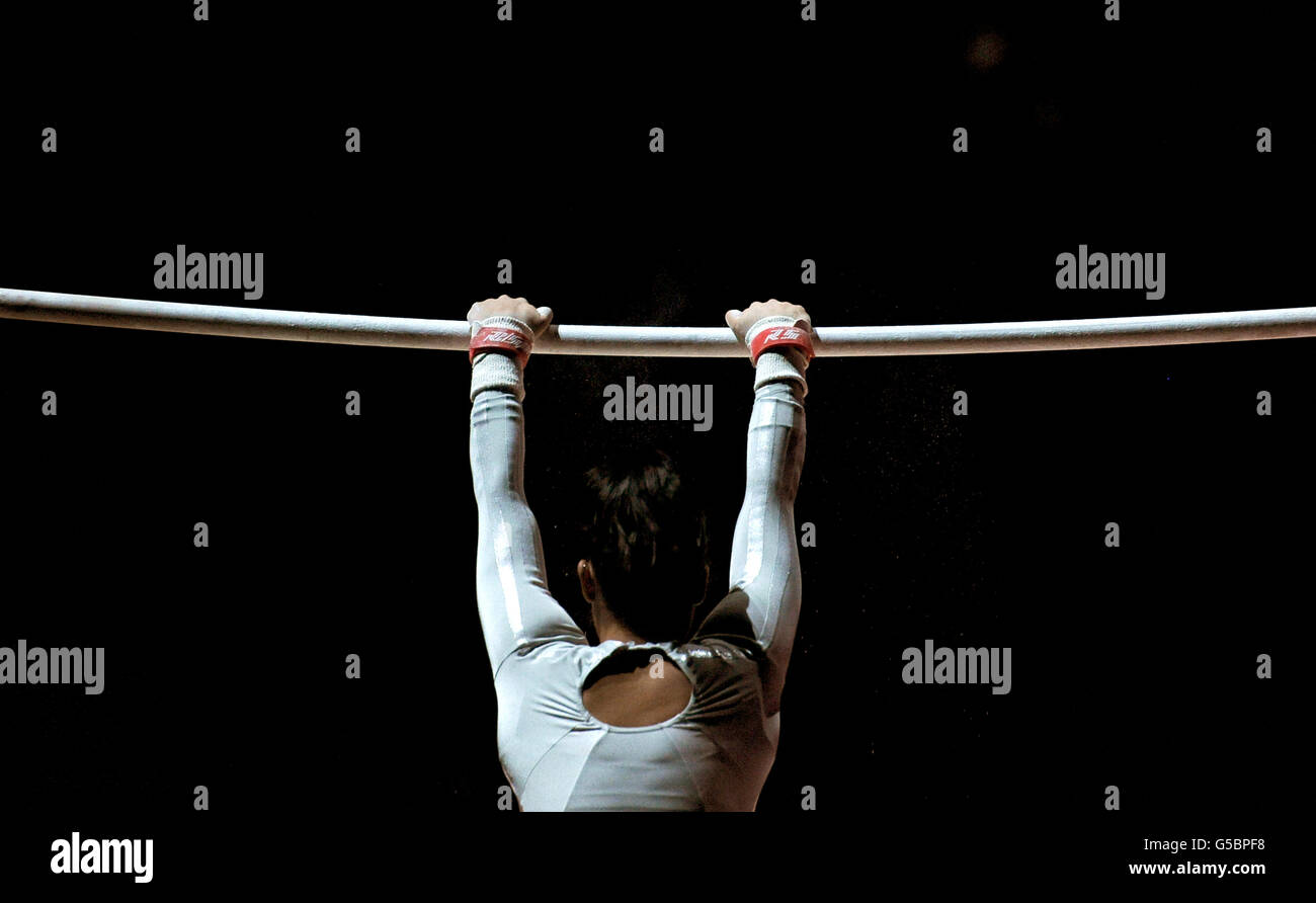 A gymnast mounts the uneven bars during the Artistic Gymnastics at the North Greenwich Arena, London Stock Photo