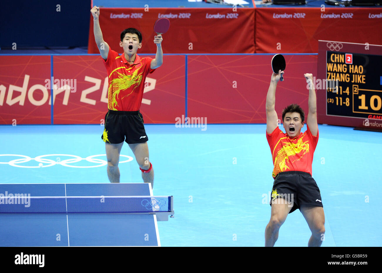 China's Zhang Jike (left) and Wang Hao celebrate as they defeat the Republic of Korea's Oh Sangeun and Ryu Seungmin during the Table Tennis team final at the ExCel centre, London. Stock Photo