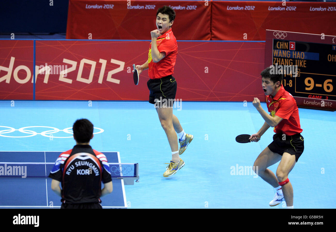 China's Wang Hao (centre) and Zhang Jike celebrate as they defeat the Republic of Korea's Oh Sangeun and Ryu Seungmin during the Table Tennis team final at the ExCel centre, London. Stock Photo