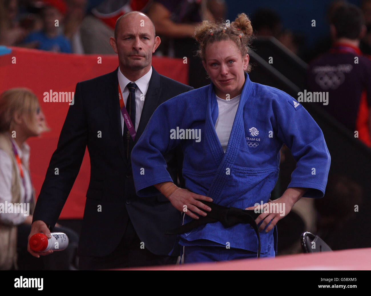 Great Britain's Sally Conway with coach Billy Cusack, shows her dejection after her defeat to Netherlands' Edith Bosch at The ExCel Arena, London. Stock Photo