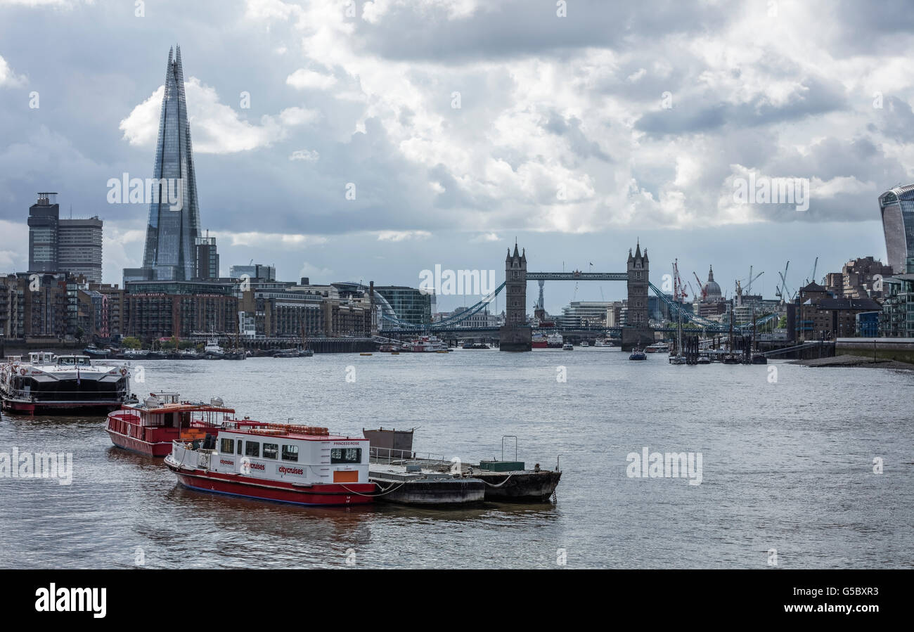 City Cruises boat on the River Thames with Tower Bridge the Shard and St Pauls Cathedral in the distance Stock Photo