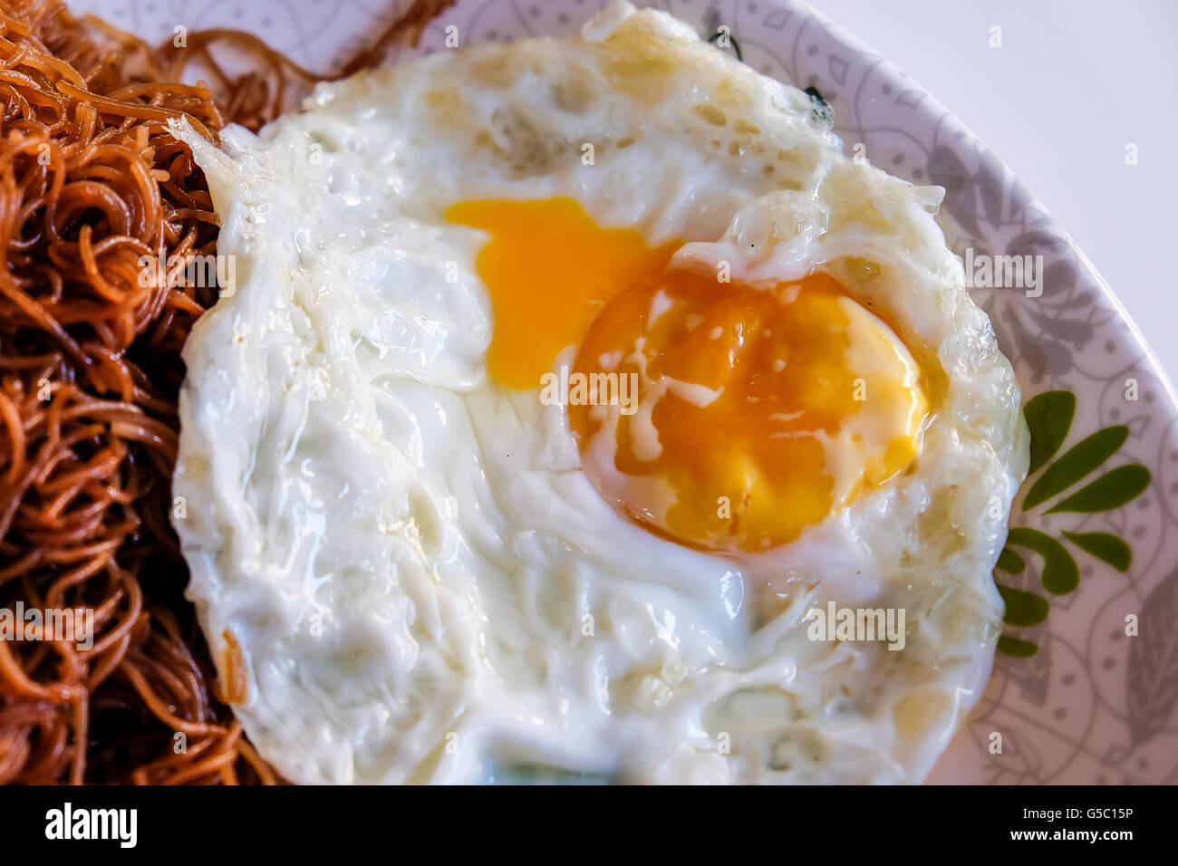 fried noodles with egg is a breakfast food choice people in Asia Stock