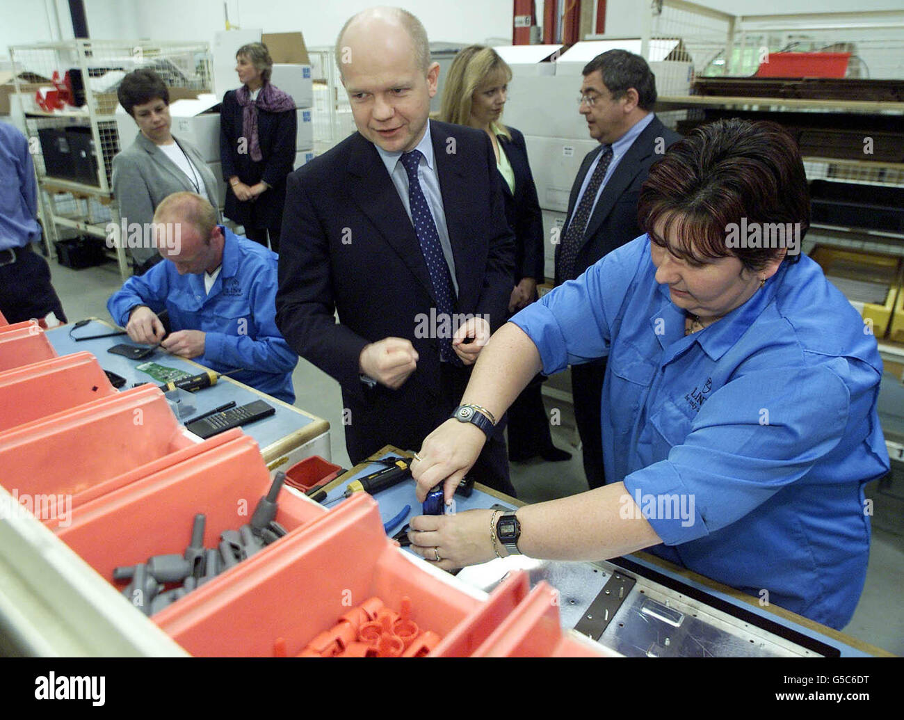 Conservative party leader William Hague (C) talks to workers on the production line as he visits the Linn Hi-fi factory near Glasgow. Stock Photo