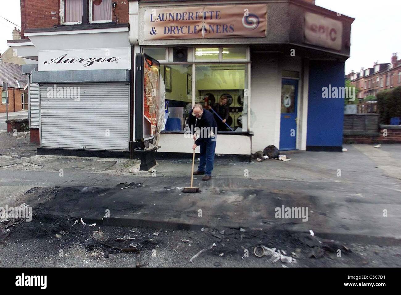 The cleanup gets underway after the night's riots in the Harehills