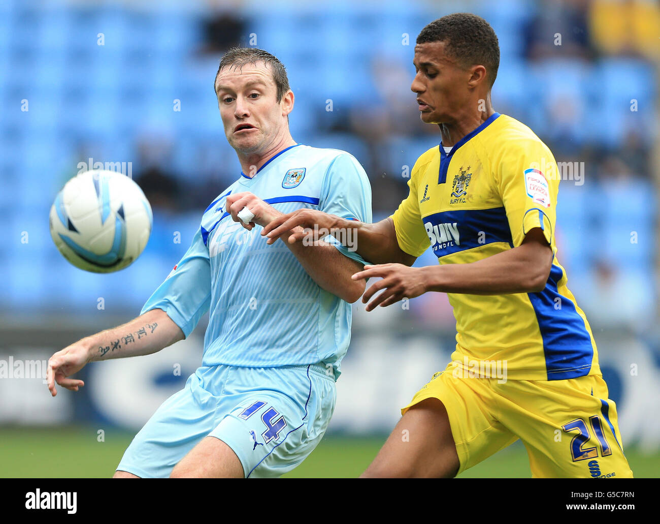 Coventry City's Stephen Elliott and Bury's Andrai Jones in action during the npower Football League One match at the Ricoh Arena, Coventry. Stock Photo