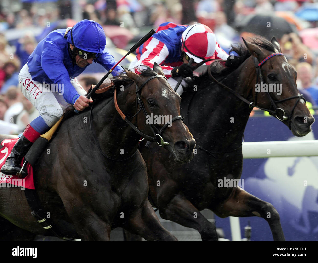Frankie Dettori and Winning Foe (left) narrowly defeat Royal Diamond and Nial McCullagh in the Betfred Ebor Handicap during day four of the 2012 Ebor Festival at York Racecourse. Stock Photo