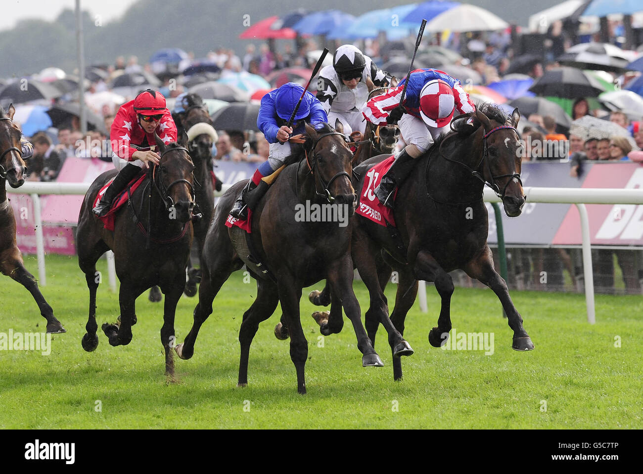 Frankie Dettori and Winning Foe (centre) narrowly defeat Royal Diamond and Nial McCullagh in the Betfred Ebor Handicap during day four of the 2012 Ebor Festival at York Racecourse. Stock Photo