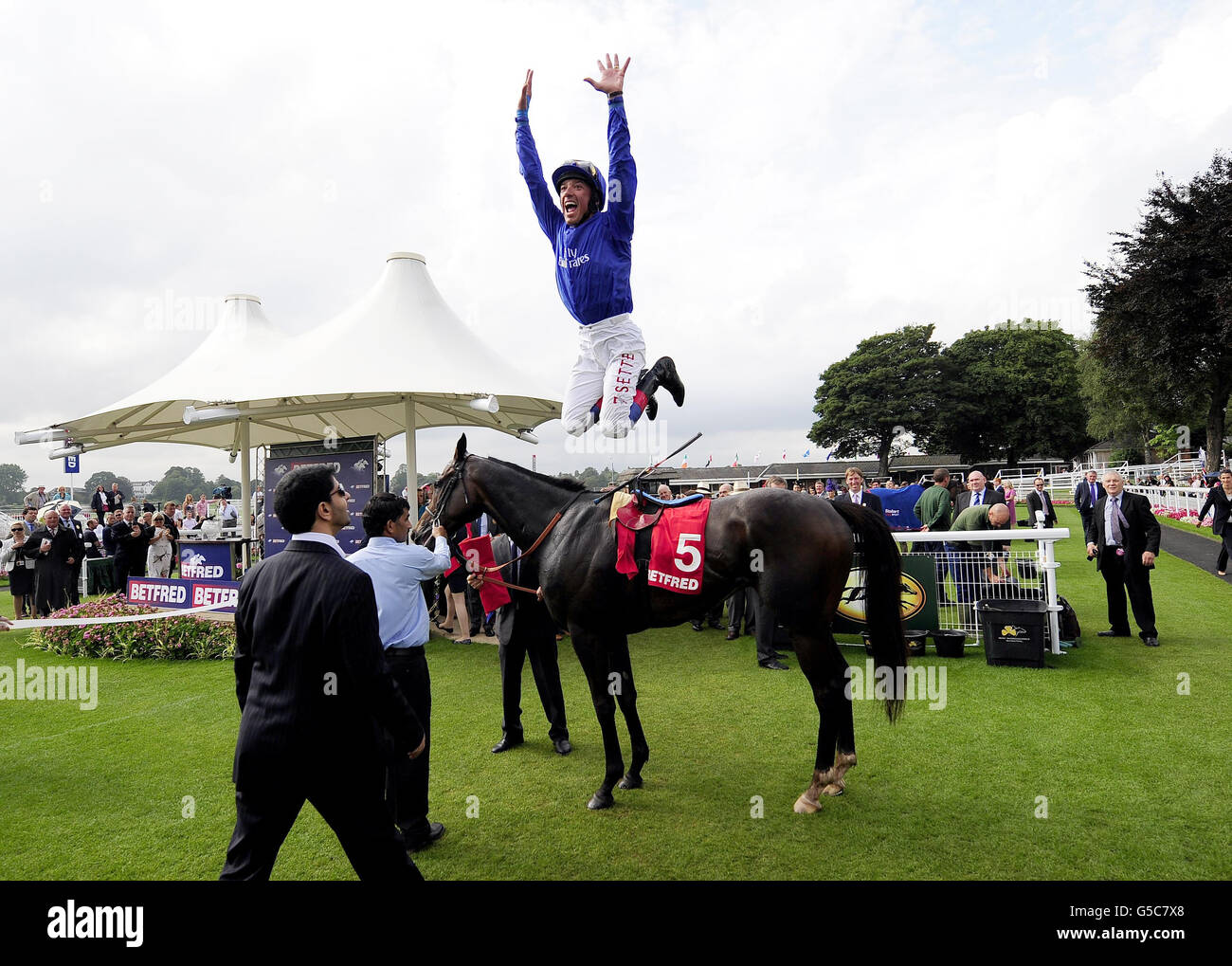 Frankie Dettori jumps from his horse after victory on Winning Foe in the Betfred Ebor Handicap during day four of the 2012 Ebor Festival at York Racecourse. Stock Photo