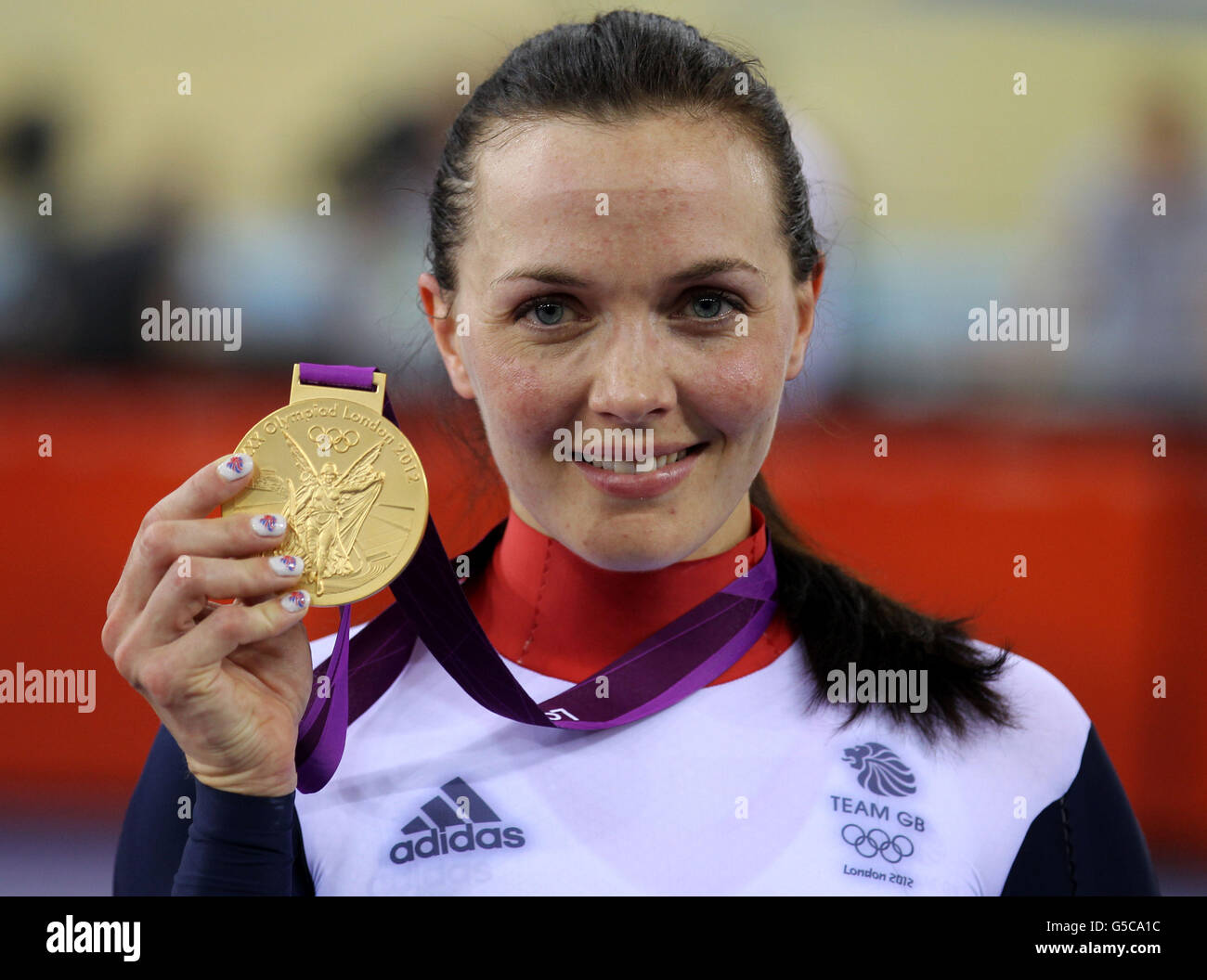 Great Britain's Victoria Pendleton celebrates with her Gold medal after winning the Women's Keirin Final at the Velodrome in the Olympic Park, during day seven of the London 2012 Olympics. Stock Photo