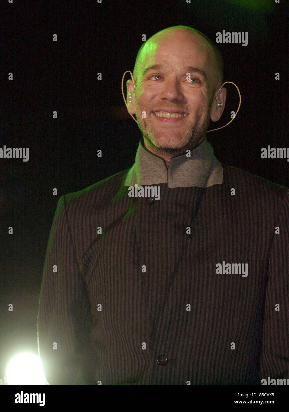 Michael Stipe, lead singer of the pop group REM, performing on stage at