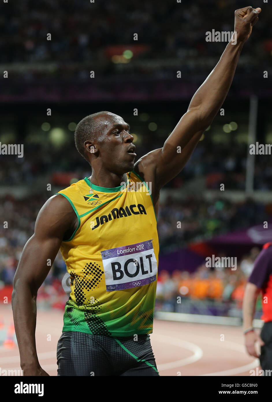 London Olympic Games - Day 9. Jamaica's Usain Bolt celebrates winning the Men's 100m Final at the Olympic Stadium on day nine of the London 2012 Olympic Games. Stock Photo