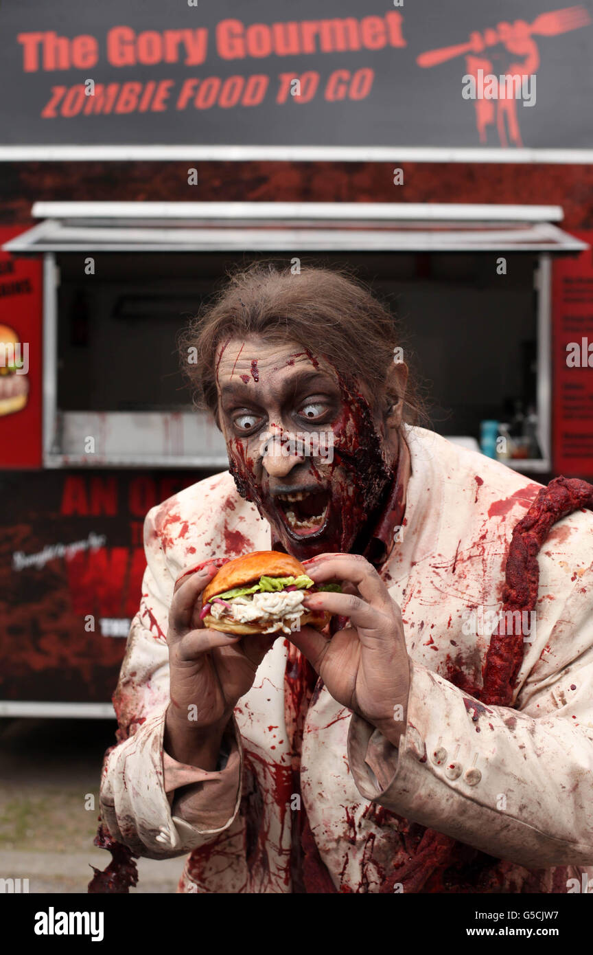 Zombie, Ashley Siberini,enjoys a brain burger at 'The Gory Gourmet' food stall in London, to promote the launch of The Walking Dead Season 2 on DVD and Blu-ray, which will be released on Monday 27th August. Stock Photo
