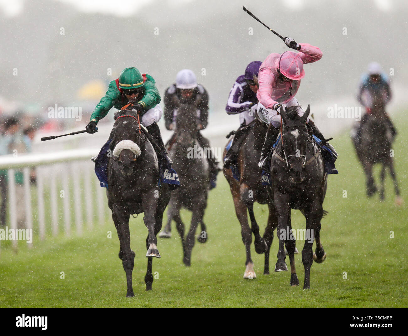 Shareta (green cap) ridden by Christophe Lemaire comes home to win the Darley Yorkshire Oaks from second placed The Fuge (pink) ridden by William Buick Stock Photo