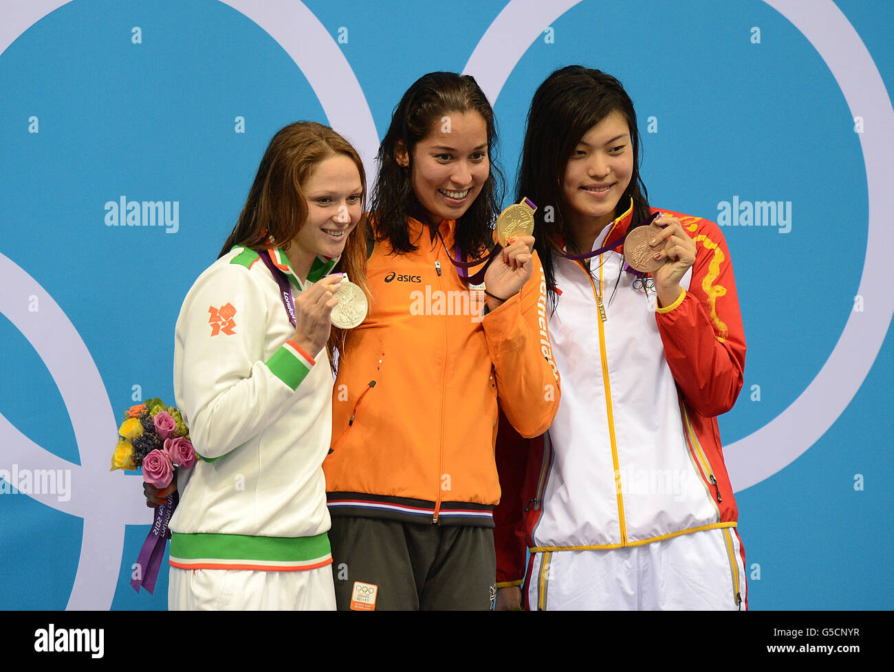 (left to right) Silver Medalist Belarus' Aliaksandra Herasimenia, Gold Medalist Netherlands' Ranomi Kromowidjojo and Bronze Medalist Yi Tang celebrate with their medals after the Women's 100m Freestyle Final at the Aquatics Centre in the Olympic Park, London. Stock Photo