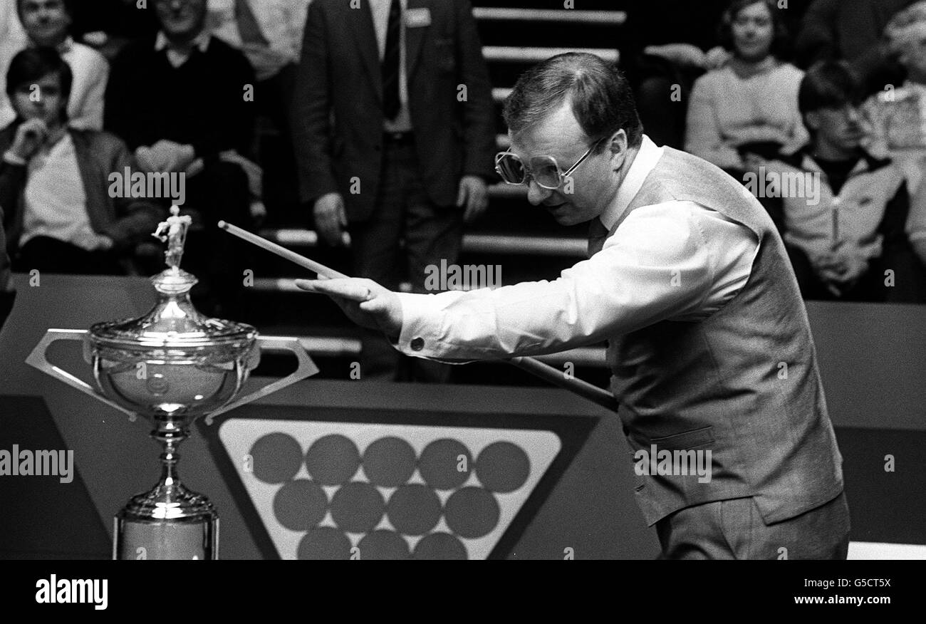 Snooker finalist Dennis Taylor looks to the World Snooker Championship trophy for inspiration before the World Snooker Championship final against Steve Davis in Sheffield. Stock Photo