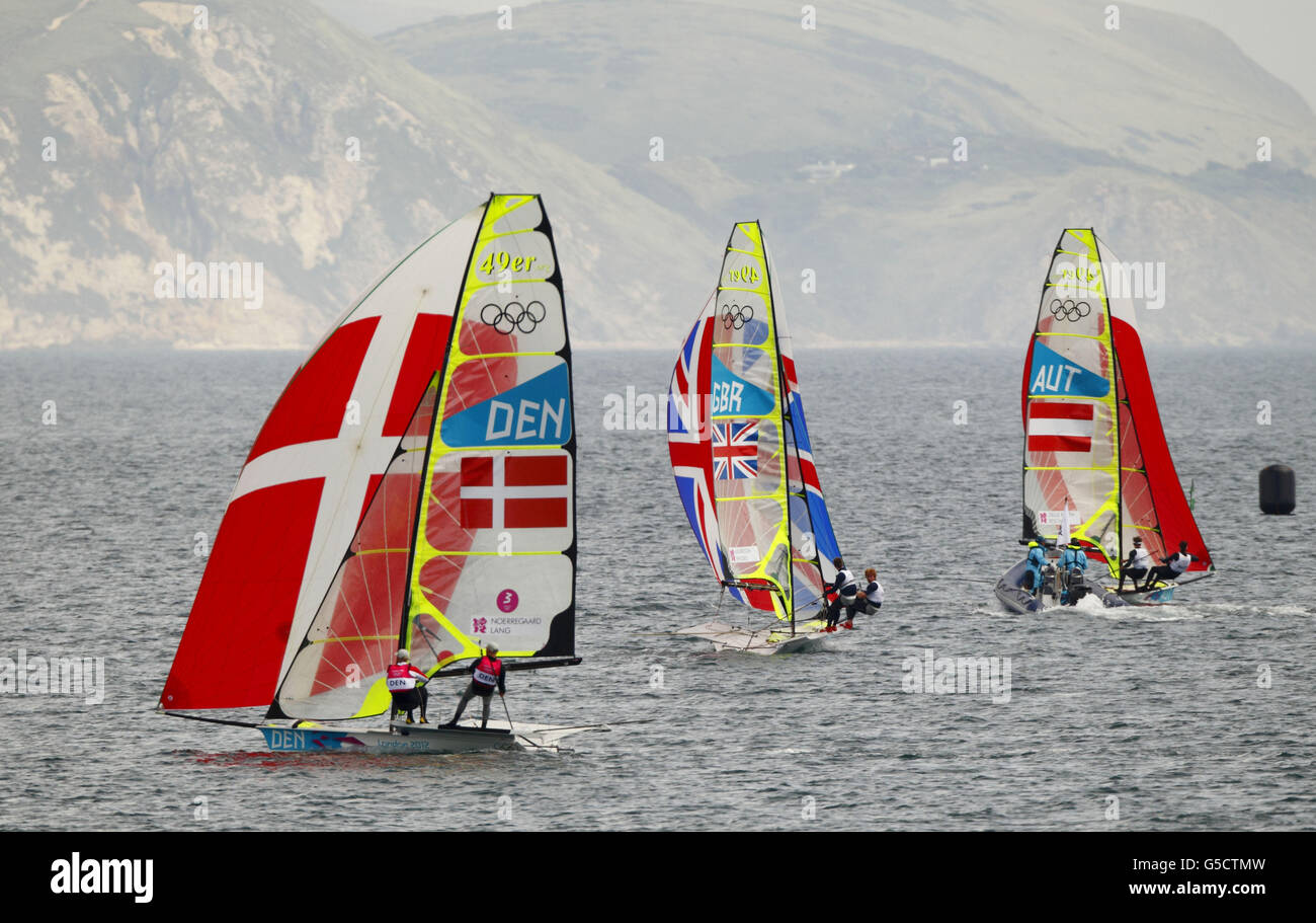 Great Britain's Stevie Morrison and Ben Rhodes (centre) are chased by the Danish team in the Men's 49er class sailing event at the Olympics in Weymouth and Portland today. Denmark snatched bronze from GB on the final downwind run. Stock Photo