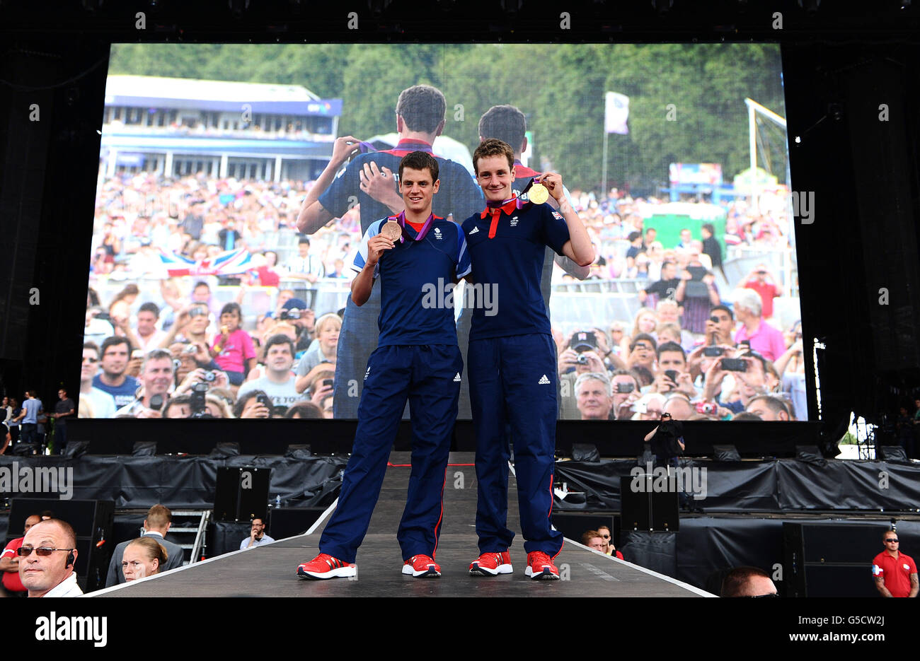 Jonny (left) and Alistair Brownlee show off their bronze and gold medals respectively won in the Mens Triathlon at BT London Live, a series of outdoor concerts to celebrate the Olympic and Paralympic Games, at Hyde Park in London. Stock Photo