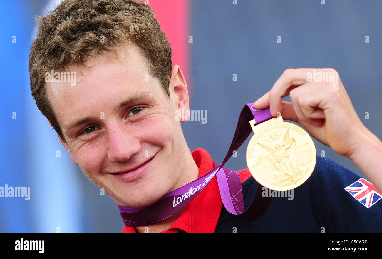 Alistair Brownlee shows off his gold medal won in the Mens Triathlon at BT London Live, a series of outdoor concerts to celebrate the Olympic and Paralympic Games, at Hyde Park in London. Stock Photo