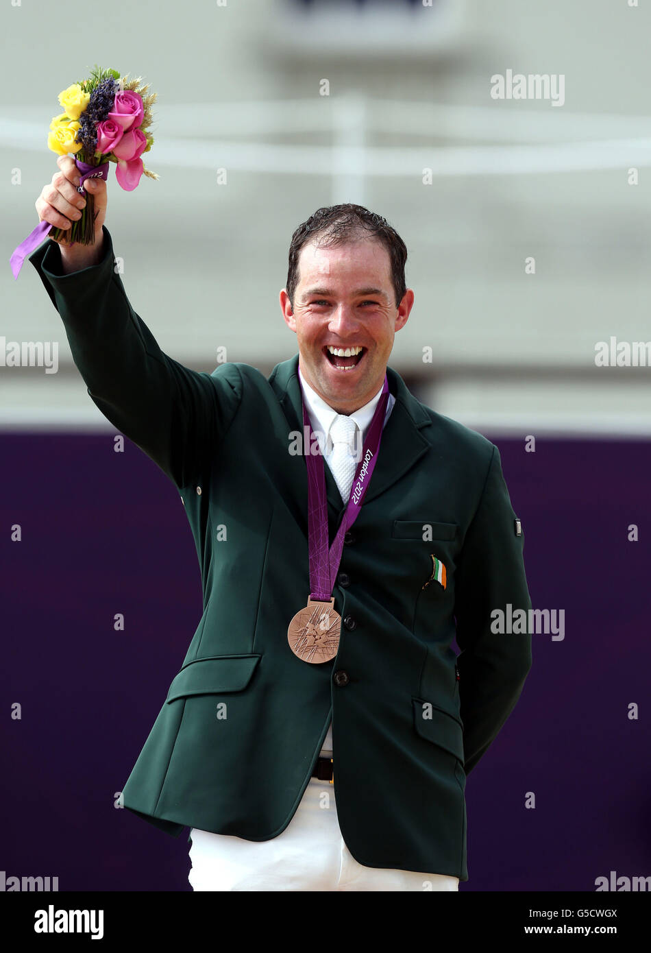 Ireland's Cian O'Connor with his bronze medal after the Individual Jumping Final at Greenwich Park, on the twelfth day of the London 2012 Olympics. Stock Photo