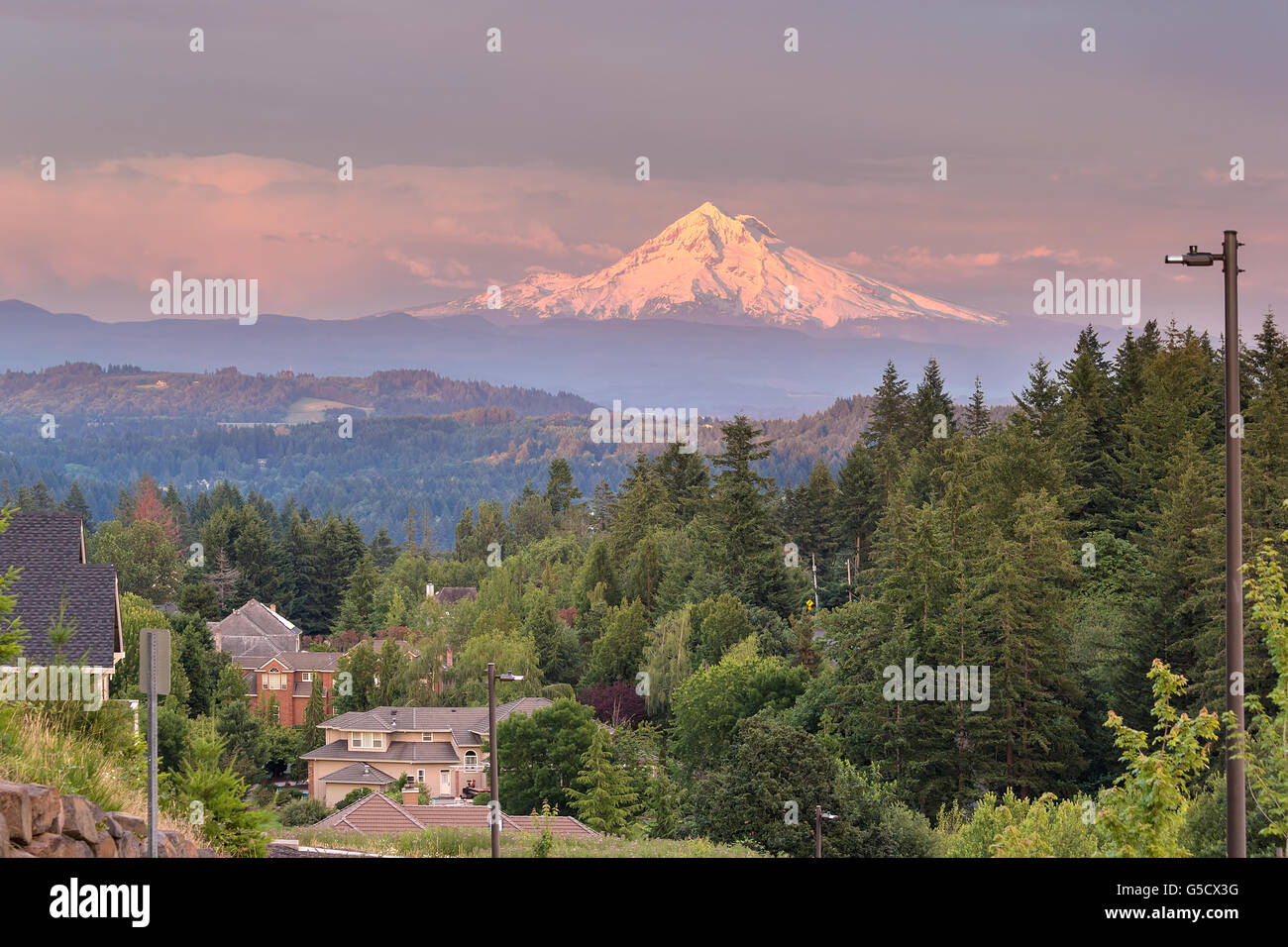 Mount Hood evening alpenglow during sunset from Happy Valley Oregon residential neighborhood in Clackamas County Stock Photo
