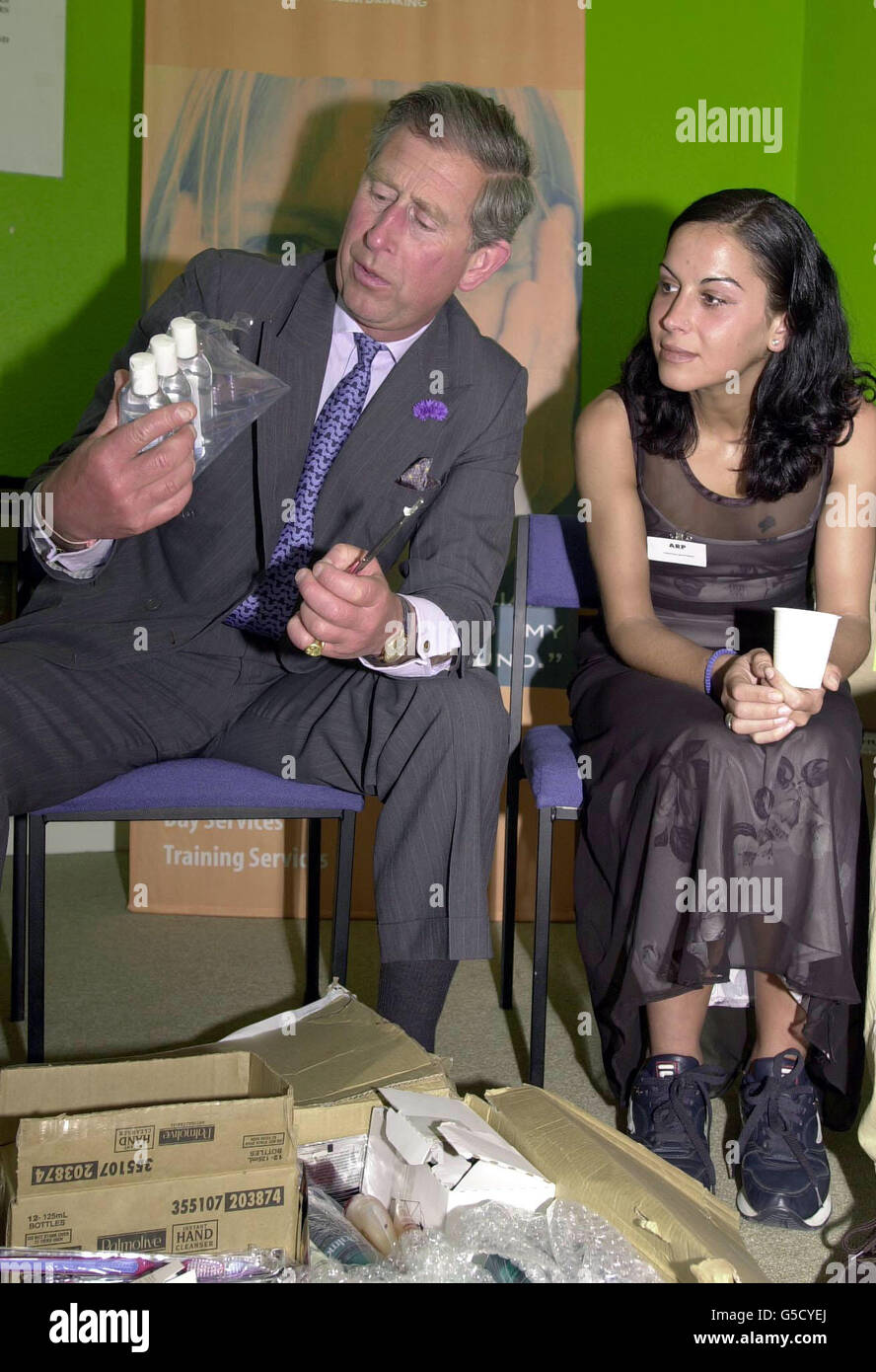 The Prince of Wales examines bottles of shampoo with Christina Martinez, a resident at the Alcohol Recovery Project, in Camberwell, south London. *...The Prince was there to see the work of Inkindirect, a charity he founded four years ago, which offers businesses solutions for disposing of surplus stock to benefit the country's needy. Stock Photo