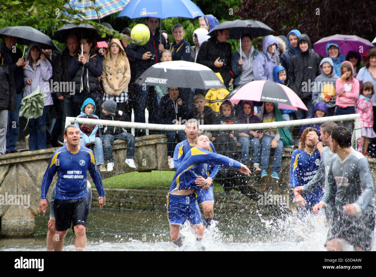Bourton Rovers 1st XI, playing in light blue, clash with Bourton Rovers 2nd XI during the annual August Bank Holiday Monday River Football match at Bourton on the Water, Gloucestershire. Picture date: Monday August 27, 2012. The match, watched by hundreds of spectators braving the rain, ended 2-2. See PA story SPORT River. Photo credit should read: Rod Minchin/PA Wire Stock Photo