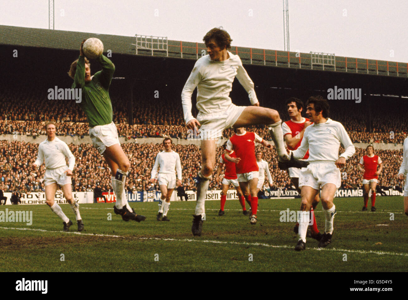Gary Spake, Leeds United saves with the help of Allan Clarke also of Leeds United who is also airbourne Stock Photo