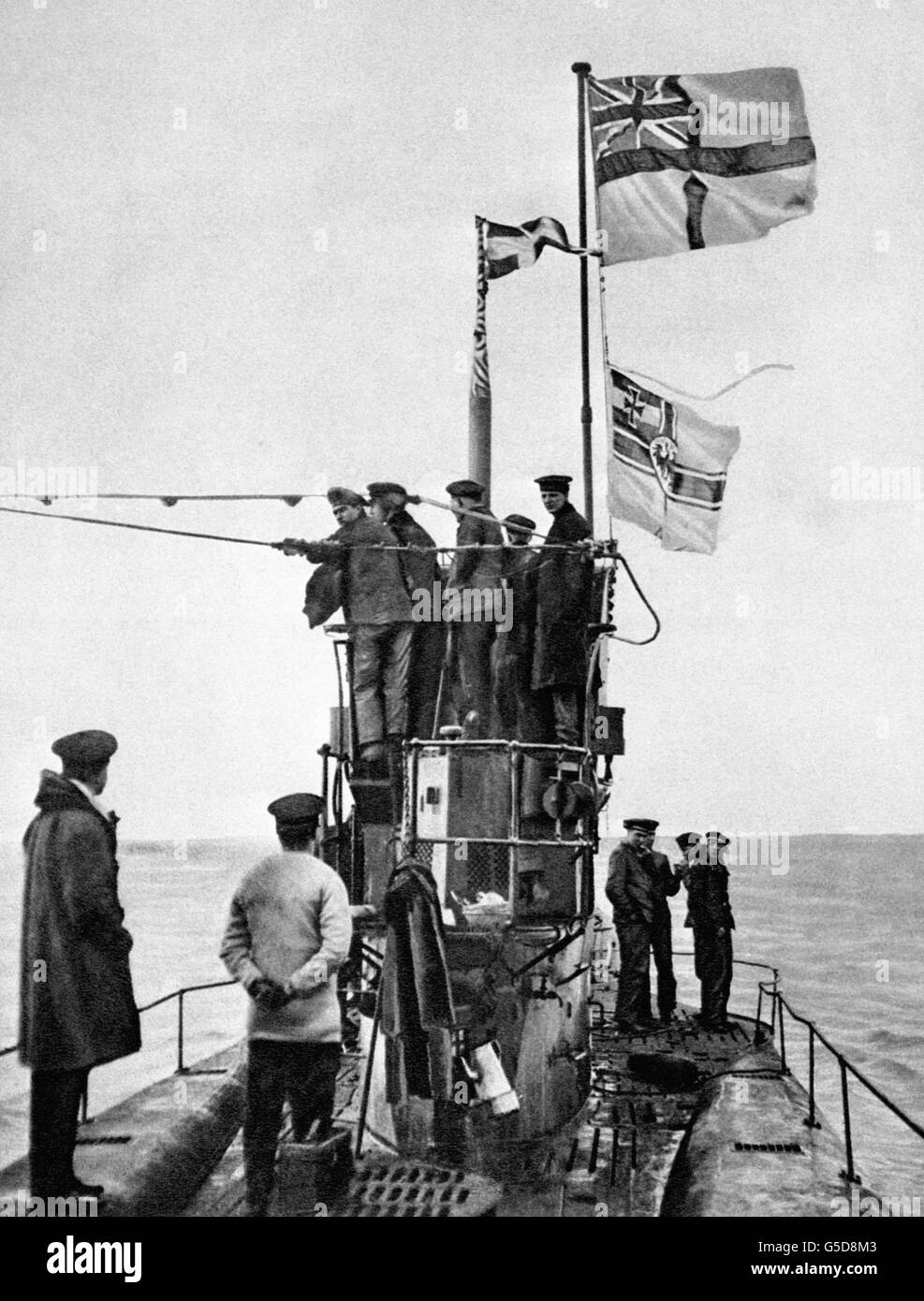 A view of the surrender of the German submarine U-48 to the Royal Navy at the Essex port of Harwich. The U-48 was one of 39 U-Boats to surrender, most of them in perfect condition. The White Ensign can be seen flying above the Imperial German Navy flag. Stock Photo